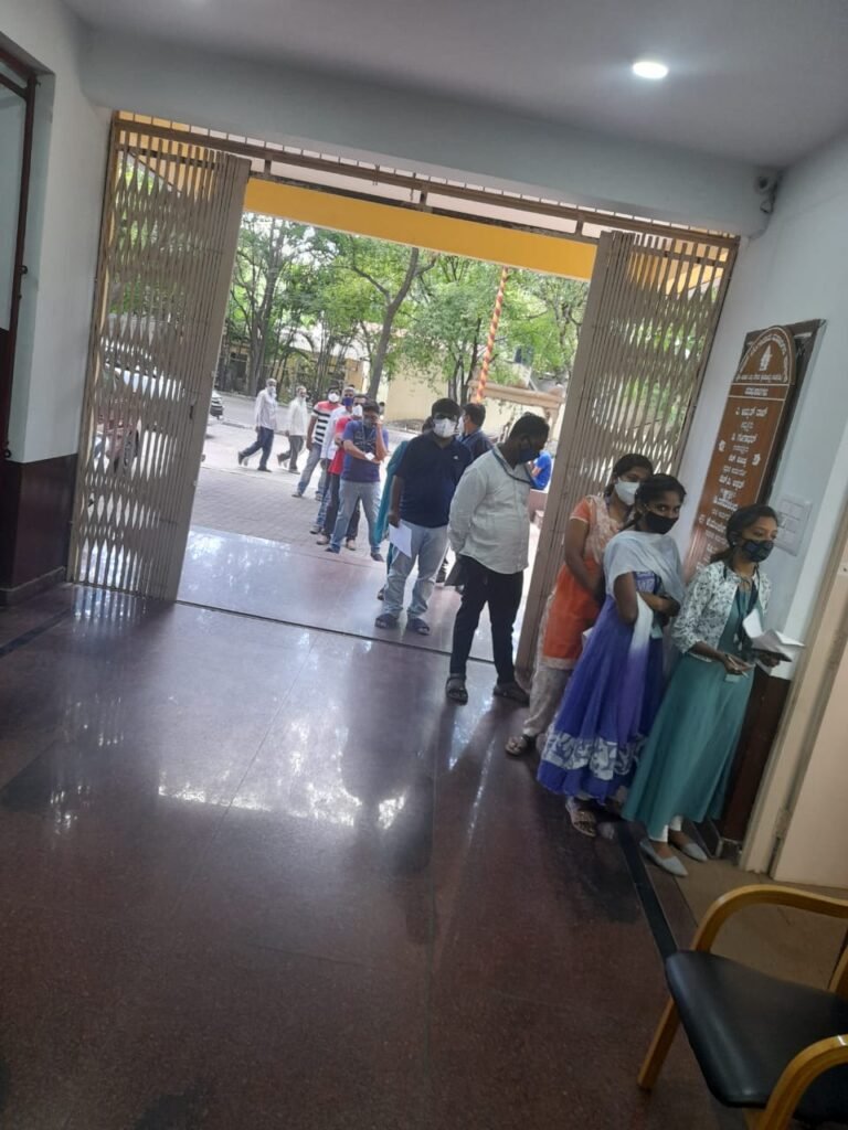 BBMP Class 4 employee caught stealing 2 Covishield vials 2 BBMP employees standing in queue for vaccination